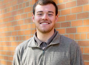 Photo of a young smiling white man with light brown hair